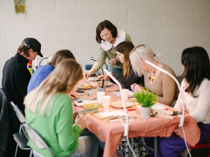 Group of women at around a table in a creative workshop space